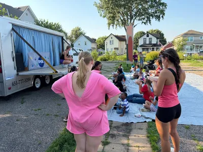 Leaders serving at an outdoor neighborhood kids event